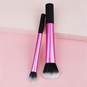 Detailed shot of pink metallic makeup brushes with soft black and white gradient bristles