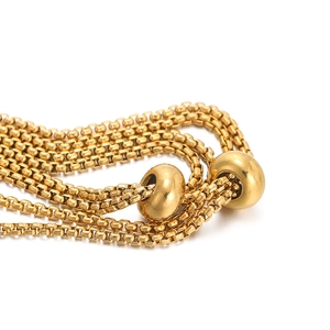 Detailed close-up of adjustable gold-plated box chain with sliding polished metal beads