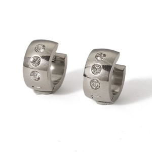 Detailed close-up of silver stainless steel huggie earrings with three inset rhinestones