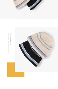 Close-up of black and beige knitted fisherman hats with contrast stripe textures
