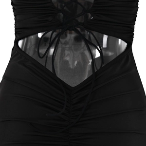 Detail of black strapless dress featuring waist cut-out and ruched lace-up design