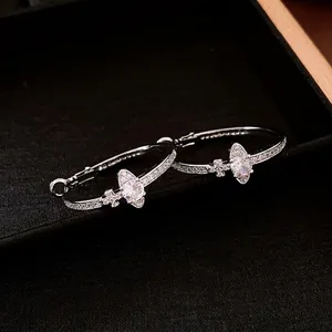 Silver marquise-cut zircon saturn hoop earrings with pavé setting in a velvet jewelry box