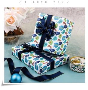 Detail of cartoon gift wrap with blue ribbon and gold edges for kids birthday presents