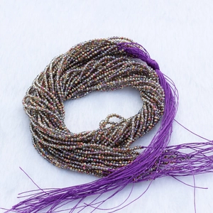 2mm faceted iridescent bronze crystal beads with a decorative purple silk tassel