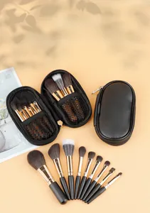 Close-up of 9-piece mini makeup brush set with elegant black leather zipper pouch