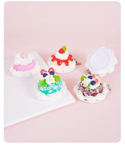 Top view of mini resin dessert charms with realistic strawberry and cream details