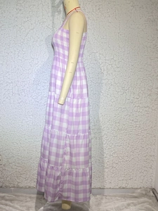 Side view detail of a tiered lavender and white checkered maxi dress on a mannequin