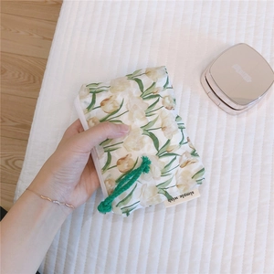 Detailed macro shot of floral cotton pouch showing tulip pattern and simple wish woven label