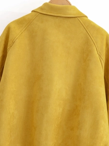 Close-up of the collar and shoulder stitching on a mustard yellow suede jacket