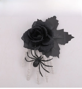 Detail of gothic Halloween hair clip featuring black rose, spider, and skeleton hand claw