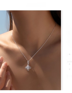 Close-up of sparkling floral pendant necklace with pavé stones on a model's neck