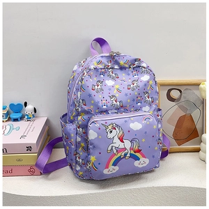 Close-up of purple unicorn backpack with rainbow patterns and front zipper pocket