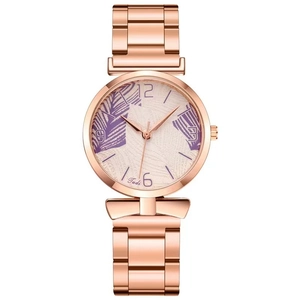 Detailed macro of rose gold watch dial with purple palm leaf pattern and steel strap