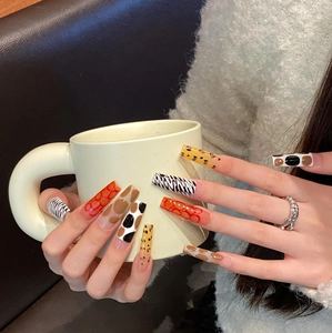 Extra long square press-on nails featuring mixed animal prints and glossy finish
