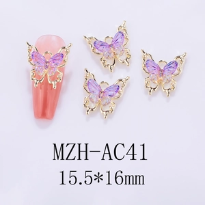 Detail of 3D purple resin butterfly nail charms with gold metal edges and laser finish