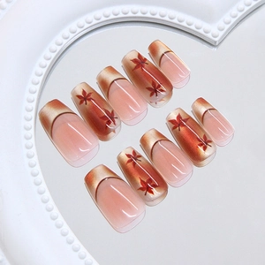 Cat eye press-on nails with autumn maple leaf design and French gradient effect