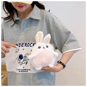 Close-up of white plush bunny crossbody bag with pink ears and elegant metal chain strap