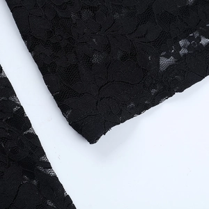 Close-up of black floral lace fabric showing hollow patterns and fine sewing craftsmanship