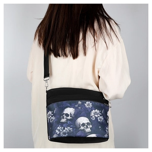 Detail view of black gothic crossbody bag featuring skull and purple floral print on model