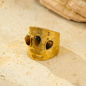 Vintage wide gold hammer-textured ring with three teardrop tiger eye stones on stone base
