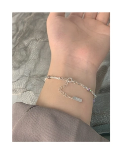 Close-up of S925 sterling silver bracelet with purple crystal beads on woman wrist