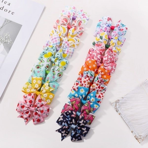 Set of 20 colorful children daisy and fruit print bow hair clips on white background