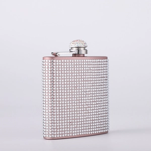 Rose gold stainless steel hip flask covered in sparkling rhinestones with a matching cap