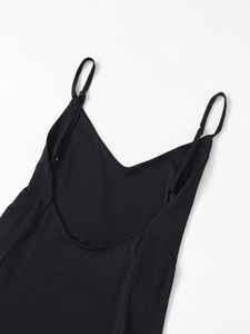 Detail of adjustable thin straps and deep V-neckline on a black crinkle fabric dress