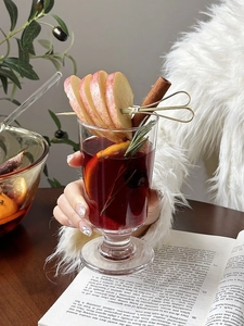 Close-up of elegant mulled wine glass with sliced oranges and aromatic spices