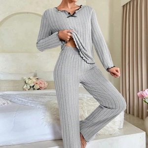 Grey two-piece rib-knit loungewear set with black ruffle trim and decorative bow detail