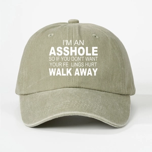 Detail of khaki washed cotton baseball cap featuring printed white slogan text on brim
