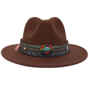 Detail of dark brown felt cowboy hat with bohemian turquoise stone and ethnic braided band