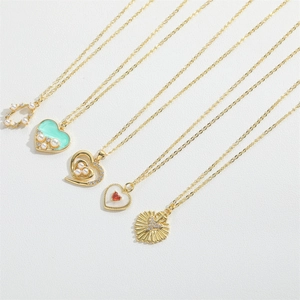 Detail of assorted gold heart pendants with pearls and mint green enamel accents