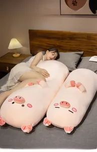 Close-up of a long plush pig pillow being held in bed for cozy sleep support