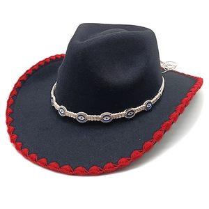 Detail of black fedora hat with red crochet edge and bohemian evil eye beaded strap