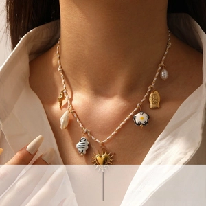 Detail of woven rope necklace with colorful ceramic flowers and cute fish charms on model