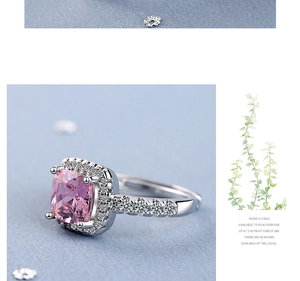 Macro side view of a cushion cut pink gemstone ring with micropavé diamond settings