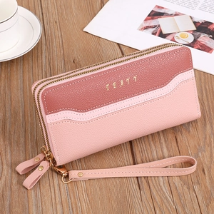 Detail of pink dual-zipper long wallet in pebble leather with detachable wrist strap