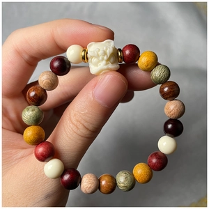 Macro shot of colorful wooden beads bracelet with a white lion guardian carving detail