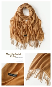 Detailed view of camel cashmere scarf texture and delicate fringed edge details