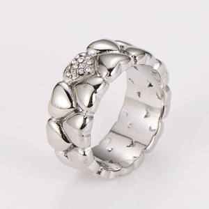 Detailed close-up of silver heart link ring featuring micro-pave crystals on polished steel