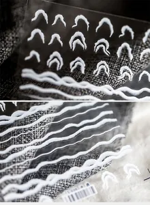 Macro detail of 3D embossed white water wave patterns on nail art stickers