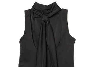 Detail of the black satin sleeveless top featuring a tied bow neckline and silky texture