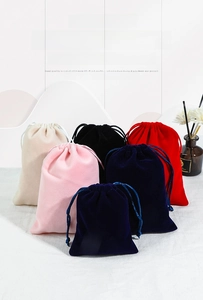 Close-up of assorted drawstring velvet pouches for jewelry storage and gift packaging
