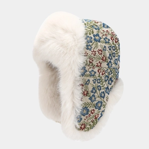 Detailed close-up of winter floral ushanka hat showing soft faux fur and floral fabric