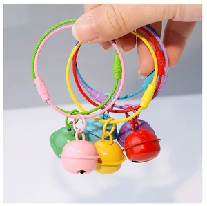 Detail of colorful plastic-coated steel wire keychains with matching matte metal bells