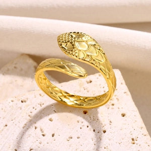 Macro shot of gold snake ring with detailed scale texture and head carving