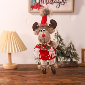 Detail of Christmas reindeer plush ornament with red knit hat and striped scarf
