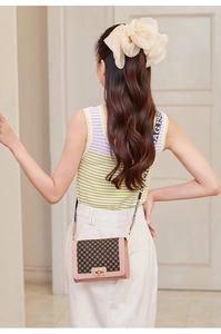 Detail showing the contrast canvas pattern and pink leather trim with metal turn-lock