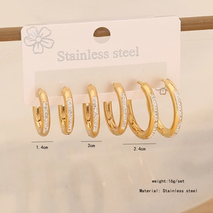 Detailed view of three gold stainless steel hoop earrings with sparkling rhinestones
